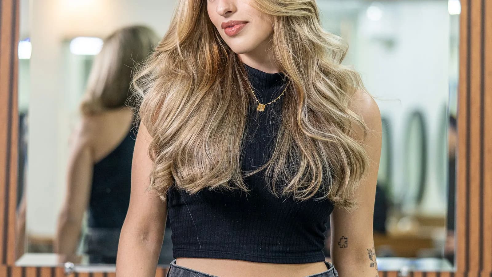 A stylist hand-painting balayage colour onto a client's hair at Sultan Hair & Beauty in Cardiff